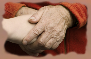 Older persons's hands holding younger persons's hands representing care and compassion of hospice volunteers 